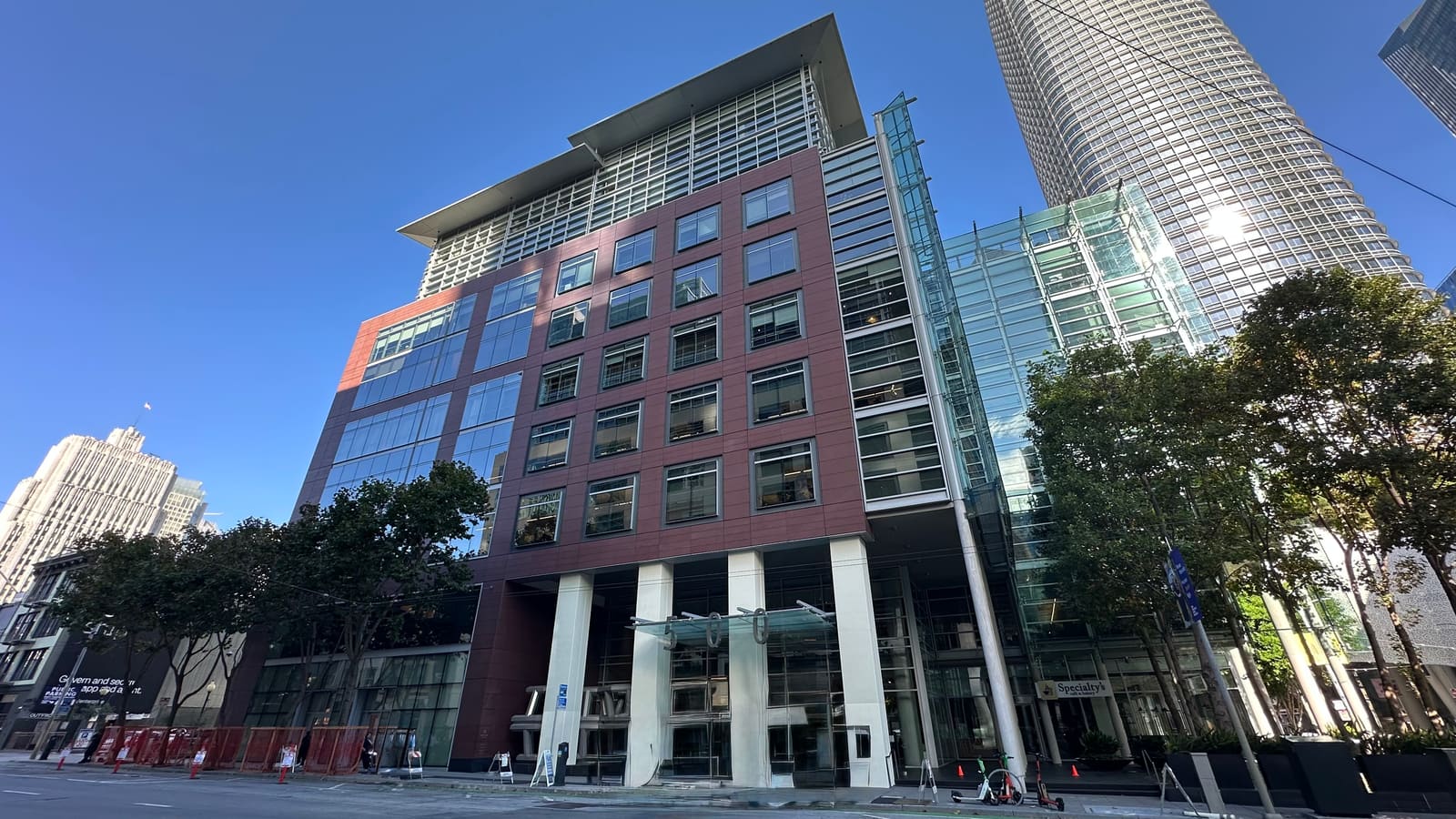 The red-brick and glass office building at 500 Howard Street in SoMa, home to Anthropic, with Salesforce Tower rising behind it.